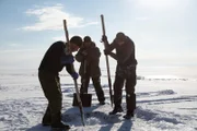 The team break the ice on Lake Baikal in prepartion to drop the ROV.