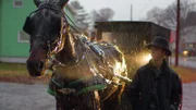 Jeremiah in the rain by a horse and buggy.
