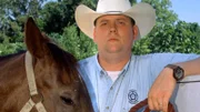 Agent Charles Jantzen with a tethered horse at the Houston SPCA horse barn.