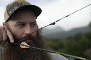 Matt Raney points an arrow on the bow.