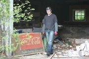 Eric standing next to the coca cola sign.