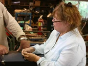 Appraiser Donna Welch helps Brian and Eric evaluate the value of their loot.