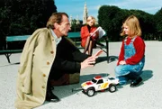 Nordeck (Ludwig Hirsch, l.) will Verlagslektorin Renate Späth (Claudia Messner, M.) mittels einer im Spielzeugauto versteckten Bombe töten. Das kleine Mädchen (Anna Katharina Baumgartner, r.) vereitelt jedoch diesen Plan ...