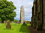Standing stone in the churchyard of All Saints Church, in the village of Rudston, East Riding of Yorkshire, England UK
