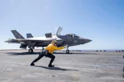 PACIFIC OCEAN (Sept. 30, 2019) Aviation Boatswain’s Mate (Handling) 2nd Class Sabrina Bales, assigned to the amphibious assault ship USS America (LHA 6, signals an F-35B Lightning II assigned to the Flying Leathernecks of  Marine Fighter Squadron (VMFA) 122 to take off from the ship’s flight deck. America is currently underway conducting routine operations.