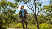Coyote Peterson hiking across rock.