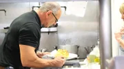 Robert inspects cauliflower, as seen on Restaurant Impossible.