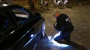 The policeman checks the documents for accuracy.