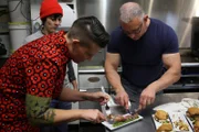 Crystal and Kiki try the crispy pork.
