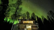 The Cosna Homestead sits under the northern lights.