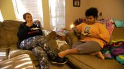 Paula and her daughter Savanna eating dinner on the couch.