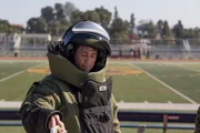 Tim Kennedy disposes of a test IED in a bomb suit.