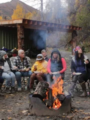 Matt, Katie, Fanny, Ron, Gauge, Maciah, Misty, Mollee, and Marty are gathered by a campfire eating.