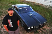 Big Chief standing in front of his car.