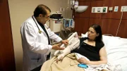 Christina post skin removal surgery on her arms and recovering in the hospital.