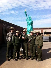 Park Rangers pose with finished cake.