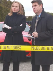 Detectives talk to a witness near Julie's abandoned car.