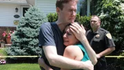Eric and his sister grieve on the front lawn.