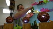 Danny adds flowers to Flower Show cake.