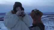 Charlie Wright thinks he spotted caribou tracks and tries to direct Stan Zuray’s attention to where the tracks are located.