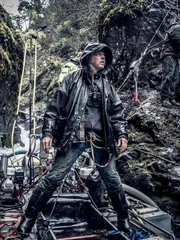 Wesley Richardson standing on the dredge, James Hamm on mountain side doing DIY.