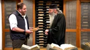 Josh Gates with Fr. Justin of Sinai in the monastery’s library in Sinai.