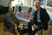 North Korea - (Left to Right) Artist and Michael Plain next to a recently painted poster.