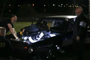 Chuck, l. checks out Dominator as he performs a few adjustments on his car.