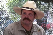 Jim Green in the evaluation tent, wearing his classic cowboy hat.