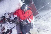 Overhalla, Norway - Jo Roger Blengslie attaching a wire to the plow truck in trouble.