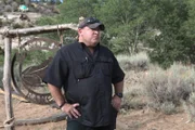 Posed shot of Jamie in front of the Blind Frog Ranch sign.