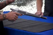 The striking profile of the Anti-Bandit Gun in Adrian Alford's hand. A double barreled 20-gauge shotgun - in pistol form.