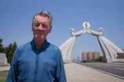 Michael Palin at the entrance to North Korea, Pyongyang.