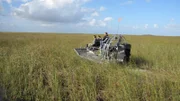 Jose and Francis travel through grassy terrain on an airboat.