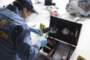 Investigators use special kits to examine and document every piece of evidence