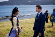 Game Master Gabby Mitchell (AMRIT KAUR) and Detective Charlie Hudson (JOHN REARDON) at the Viking memorial