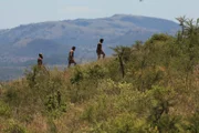 L-R: Unscharfe Aufnahme von Angel, Steven und Ryan, die in der Ferne einen Hügel hinaufgehen.