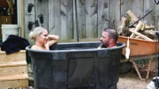 Charlie Moore and Jen Taylor sit in an outdoor bathtub in Black Mountain, NC.