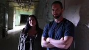 Hosts Nick Groff and Katrina Weidman stand in a hallway.