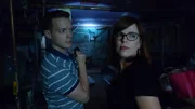 Adam and Amy investigating the basement. Amy looking back.