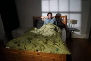 Scared man in bed.