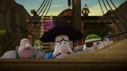 Tashi steuert das Piratenschiff durch die Schlucht. Die Piraten fürchten sich.