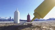 CGI image - Large bottles of mustard, mayonnaise and ketchup.