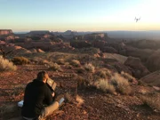 Ein Kameramann setzt mit seiner Drohne die Silhouette von Monument Valley ins Bild.