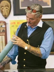 Intrigued, Billy checks out an old sealed tube labeled "80's Stuff" during the Nashville auction preview.