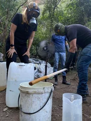 Mariana van Zeller (L) and masked subjects checking meth during cooking process.