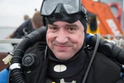 Baltic Sea, North of Gdynia, Poland - Stephen Burke gets ready to dive in the Baltic Sea.