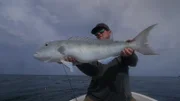Chris poses with a Job Fish he caught in Papua New Guinea.