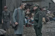 Jonah Hauer-King as Lali Sokolov & Jonas Nay as Nazi Officer Stefan Baretzki in Auschwitz.