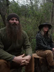 L-R: Matt and Misty Raney sit outside of their tent.